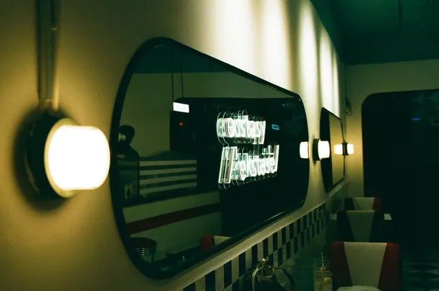 Captivating retro diner interior with neon reflection lighting, creating a nostalgic ambiance.
