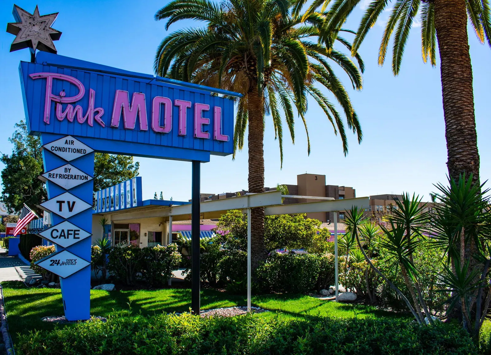 Iconic retro Pink Motel sign with palm trees in Sun Valley, Los Angeles.
