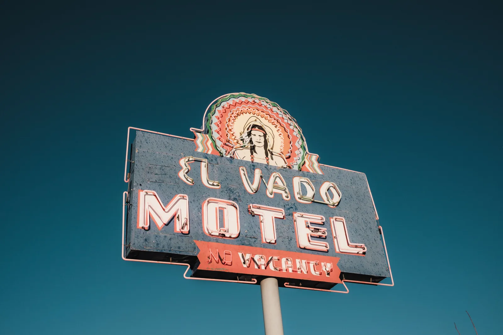 Vintage El Vado Motel sign against a clear blue sky, evoking classic Americana. How to assess a historic motel restoration tour