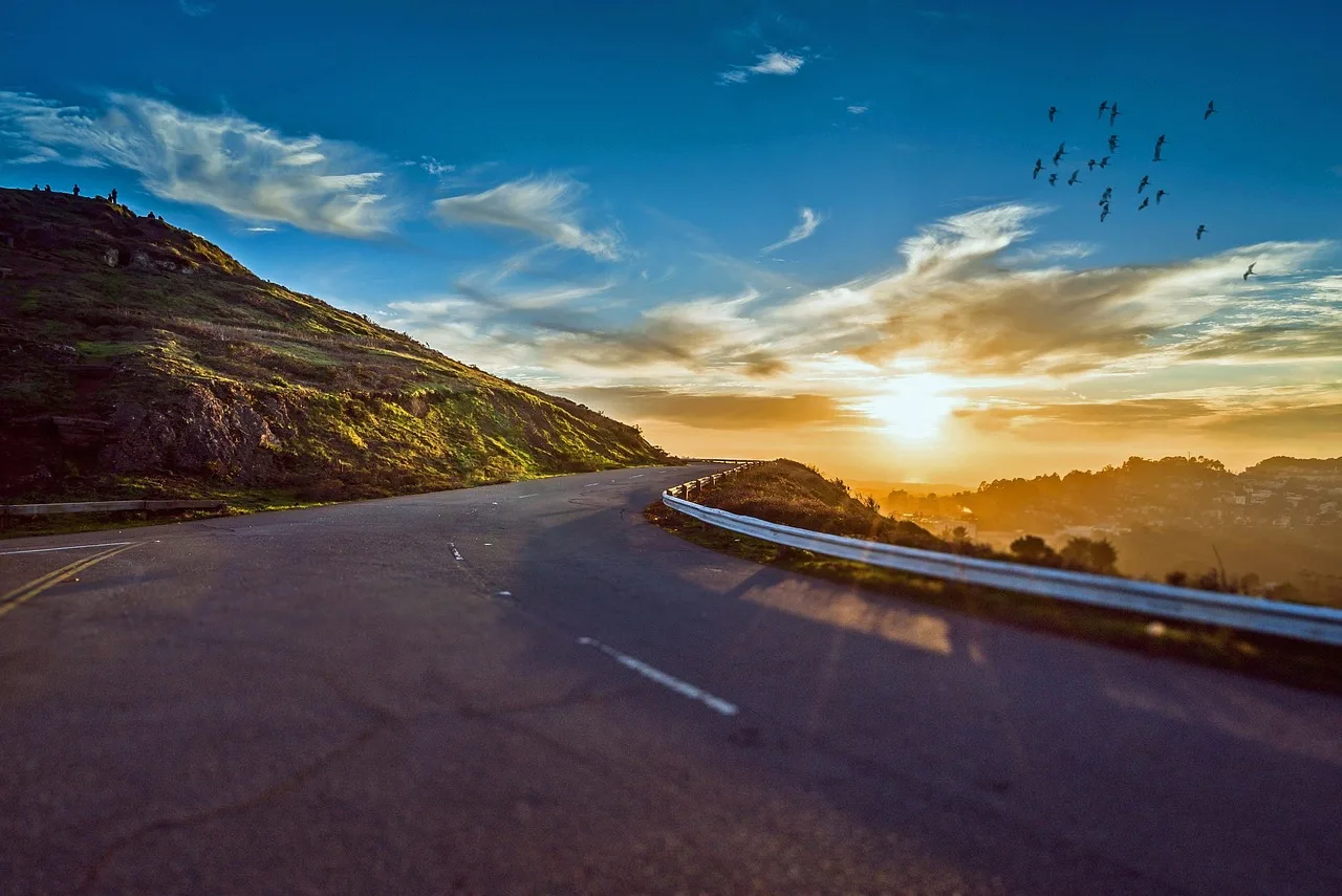 winding road, sunset, mountains, mountain landscape, street, avenue, pavement, asphalt, lane, sun, sky, road, travel, sunrise, landscape, nature, curve, trip, roadside, scenic, winding, rural, way, street, road, road, road, road, road, travel, sunrise. Packing for a day of modern roadside design: sun, asphalt and no shade