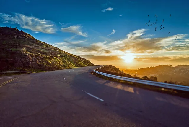 winding road, sunset, mountains, mountain landscape, street, avenue, pavement, asphalt, lane, sun, sky, road, travel, sunrise, landscape, nature, curve, trip, roadside, scenic, winding, rural, way, street, road, road, road, road, road, travel, sunrise. Packing for a day of modern roadside design: sun, asphalt and no shade